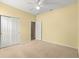 Bedroom with pale yellow walls, a closet with sliding doors, and a ceiling fan at 8961 Se 130Th Loop, Summerfield, FL 34491