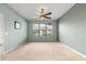 Comfortable bedroom with large window, ceiling fan, and neutral color scheme at 8961 Se 130Th Loop, Summerfield, FL 34491