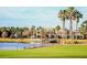 Beautiful clubhouse view with a lake and golf course in the background at 8961 Se 130Th Loop, Summerfield, FL 34491