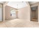 Bright dining room with tile floors, tan walls, and a decorative chandelier at 8961 Se 130Th Loop, Summerfield, FL 34491