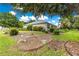 Landscaped exterior of home with beautiful yard and mature trees on a sunny day at 8961 Se 130Th Loop, Summerfield, FL 34491