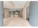 Open-concept living space with tile flooring, neutral walls, and seamless access to various rooms at 8961 Se 130Th Loop, Summerfield, FL 34491