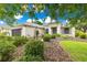 Charming one-story home showcasing manicured landscaping, a well-kept lawn, and a welcoming front entrance at 8961 Se 130Th Loop, Summerfield, FL 34491