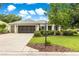 Charming single Gathering home with a well maintained lawn, mature tree, and a two-car garage at 8961 Se 130Th Loop, Summerfield, FL 34491