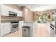 Modern kitchen featuring stainless steel appliances, granite countertops, and a center island at 8961 Se 130Th Loop, Summerfield, FL 34491