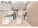 Kitchen with stainless appliances, granite countertops, island, and neutral tile flooring at 8961 Se 130Th Loop, Summerfield, FL 34491