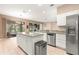 Bright kitchen with granite countertops, stainless steel appliances, and ample cabinet space at 8961 Se 130Th Loop, Summerfield, FL 34491