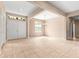 Open living room features neutral tile flooring, double doors, and recessed lighting at 8961 Se 130Th Loop, Summerfield, FL 34491