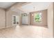 Spacious living room with tile floors, large windows, and views of the backyard at 8961 Se 130Th Loop, Summerfield, FL 34491
