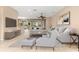 Bright living room featuring neutral decor, tile flooring, and large windows offering ample natural light at 8961 Se 130Th Loop, Summerfield, FL 34491