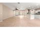 Expansive living area with neutral paint, tile floors, a ceiling fan, and an open view to the kitchen at 8961 Se 130Th Loop, Summerfield, FL 34491