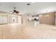 Open-concept living space with tile flooring connecting the living room to the kitchen at 8961 Se 130Th Loop, Summerfield, FL 34491