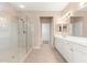 Bright bathroom with tile flooring, glass enclosed shower, and double vanity at 8961 Se 130Th Loop, Summerfield, FL 34491