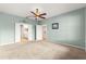 Spacious main bedroom with doors leading to the ensuite bathroom at 8961 Se 130Th Loop, Summerfield, FL 34491