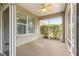 Covered patio featuring a ceiling fan, screen, and a view of the backyard at 8961 Se 130Th Loop, Summerfield, FL 34491