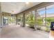 Relaxing screened-in patio with ceiling fans and views of the beautifully landscaped backyard at 8961 Se 130Th Loop, Summerfield, FL 34491