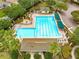 Aerial view of a large community swimming pool with lounge chairs and surrounding greenery at 8961 Se 130Th Loop, Summerfield, FL 34491