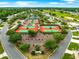 Aerial view of tennis courts and landscaping in a residential community with trees and green space at 8961 Se 130Th Loop, Summerfield, FL 34491