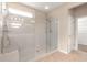 Walk-in shower with glass enclosure and neutral toned tiling at 8961 Se 130Th Loop, Summerfield, FL 34491