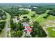 Panoramic aerial view of a community adjacent to a golf course, with clubhouse and scenic landscape at 9 Bahia Trace Loop, Ocala, FL 34472
