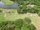Scenic aerial view of a golf course community, featuring green fairways and a peaceful lake at 9 Bahia Trace Loop, Ocala, FL 34472