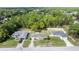 An aerial view shows a home with a large, tree-filled yard at 9 Bahia Trace Loop, Ocala, FL 34472