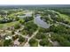 Picturesque aerial shot of a tranquil community surrounded by lush greenery and a serene lake at 9 Bahia Trace Loop, Ocala, FL 34472