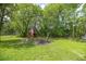 Large backyard featuring mature trees, a playhouse and a fire pit at 9 Bahia Trace Loop, Ocala, FL 34472