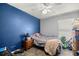 A bedroom features a blue accent wall and cement floor at 9 Bahia Trace Loop, Ocala, FL 34472