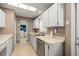 Kitchen with white cabinets and countertops and access to the laundry room at 9 Bahia Trace Loop, Ocala, FL 34472