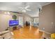 Spacious living room showcasing vaulted ceilings, a ceiling fan, wood-look flooring, and neutral paint at 9 Bahia Trace Loop, Ocala, FL 34472
