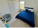 Cozy bedroom features a blue bed, a closet, and a beanbag, creating a welcoming and playful atmosphere at 9253 Sw 58Th Cir, Ocala, FL 34476