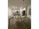 Bright dining area featuring a modern glass table and stylish chairs adjacent to a well-equipped kitchen at 9253 Sw 58Th Cir, Ocala, FL 34476