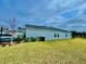 Large backyard with a well-maintained lawn and partial view of the home's side at 9253 Sw 58Th Cir, Ocala, FL 34476