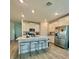 Modern kitchen featuring an island with bar stool seating, stainless steel appliances, and bright lighting at 9253 Sw 58Th Cir, Ocala, FL 34476