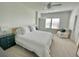 Bright main bedroom featuring neutral walls, carpet, and a ceiling fan at 9253 Sw 58Th Cir, Ocala, FL 34476