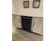 A wine cooler is seen underneath a quartz countertop and white cabinets at 9253 Sw 58Th Cir, Ocala, FL 34476