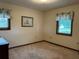 Bright bedroom with neutral walls, two windows with valances, and brown trim at 9622 Se 71St Ct, Ocala, FL 34472