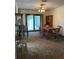Dining room featuring a wood table and chairs, cabinet, sliding glass doors, and carpet at 9622 Se 71St Ct, Ocala, FL 34472