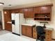 Spacious kitchen with ample wooden cabinets, a work desk, and a white refrigerator at 9622 Se 71St Ct, Ocala, FL 34472