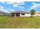 Well-maintained backyard with a screened-in patio and lush green lawn at 9865 Sw 105Th Ct, Ocala, FL 34481