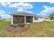 Backyard view of the screened-in lanai and landscaping at 9865 Sw 105Th Ct, Ocala, FL 34481