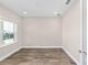 This bedroom has natural light from the large window and luxury vinyl plank flooring at 9865 Sw 105Th Ct, Ocala, FL 34481