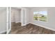 Sunlit bedroom features luxury vinyl plank flooring and a window with views of the outdoors at 9865 Sw 105Th Ct, Ocala, FL 34481