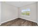 Empty bedroom with wood-look flooring and a bright window at 9865 Sw 105Th Ct, Ocala, FL 34481