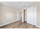 Bright bedroom features luxury vinyl plank flooring and a double-door closet for ample storage at 9865 Sw 105Th Ct, Ocala, FL 34481