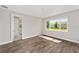 Bright bedroom with wood-look flooring and a large window providing lots of natural light at 9865 Sw 105Th Ct, Ocala, FL 34481