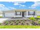 Inviting single-story home boasting a brick driveway, well-kept lawn, attached garage, and manicured landscaping at 9865 Sw 105Th Ct, Ocala, FL 34481
