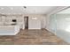 Open floor plan with hardwood floors offers a combined kitchen and living area, enhanced by a chandelier at 9865 Sw 105Th Ct, Ocala, FL 34481