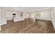 Open-concept floor plan showcases the hardwood floors, kitchen with island, and lots of natural light at 9865 Sw 105Th Ct, Ocala, FL 34481